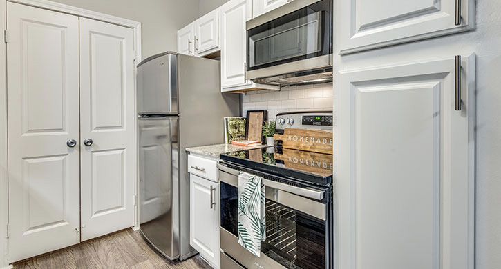 Modern kitchen with white cabinets and stainless steel appliances